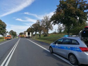 Zdjęcia ze śmiertelnego  wypadku w Ostaszewie pod Toruniem. Ujęcie  z perspektywy radiowozu policji, na aucie  napis policja.  W oddali miejsce wypadku.