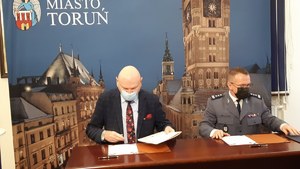 Prezydent Miasta Torunia i Komendant Miejski policji w Toruniu podczas podpisywania porumienia.