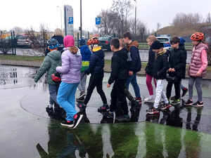 dzieci zdają egzamin na kartę rowerową na placu manewrowym