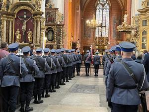 umundurowani policjanci stoją w kościele