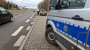 Policjant ruchu drogowego na drodze. Przeprowadza kontrolę drogową oraz czuwa nad bezpieczeństwem podróżujących.