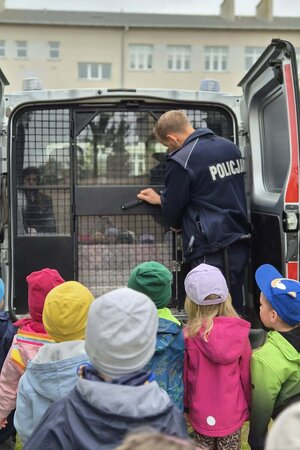 Na zdjęciach widać umundurowanych policjantów w trakcie spotkań z najmłodszymi z oddziałów przedszkolnych.